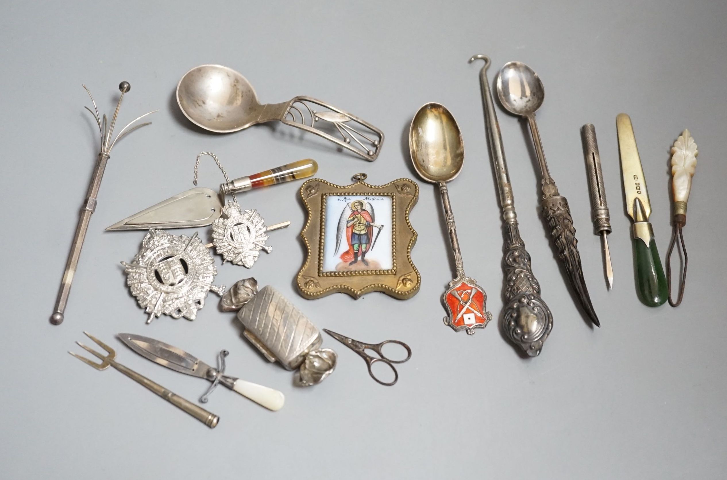 Sundry small silver etc. including a Danish sterling caddy spoon, by Franz Hingelberg, 9.7cm, nephrite handles silver gilt paper knife, swizzle stick, button hook, agate handled trowel bookmark, two badges etc.